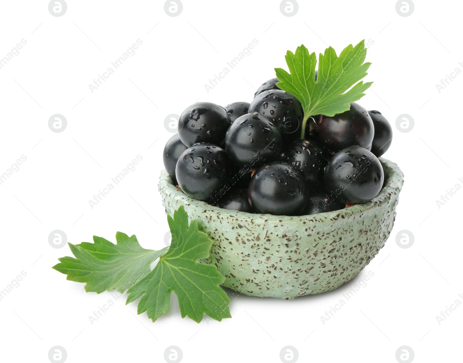 Photo of Fresh ripe black currant berries with leaves isolated on white