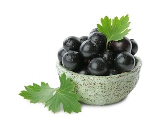 Fresh ripe black currant berries with leaves isolated on white