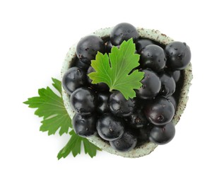 Photo of Fresh ripe black currant berries with leaves isolated on white, top view