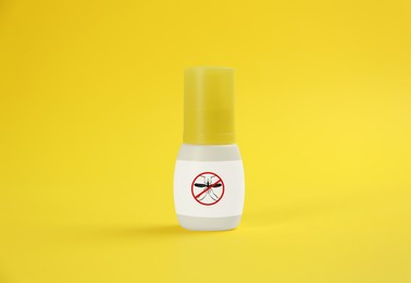 Mosquito spray on yellow background. Insect repellent