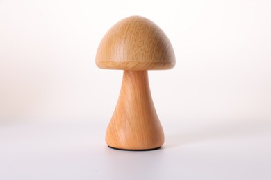 Photo of Decorative wooden mushroom figure isolated on white