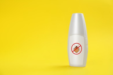 Image of Insect repellent in spray bottle on yellow background, space for text