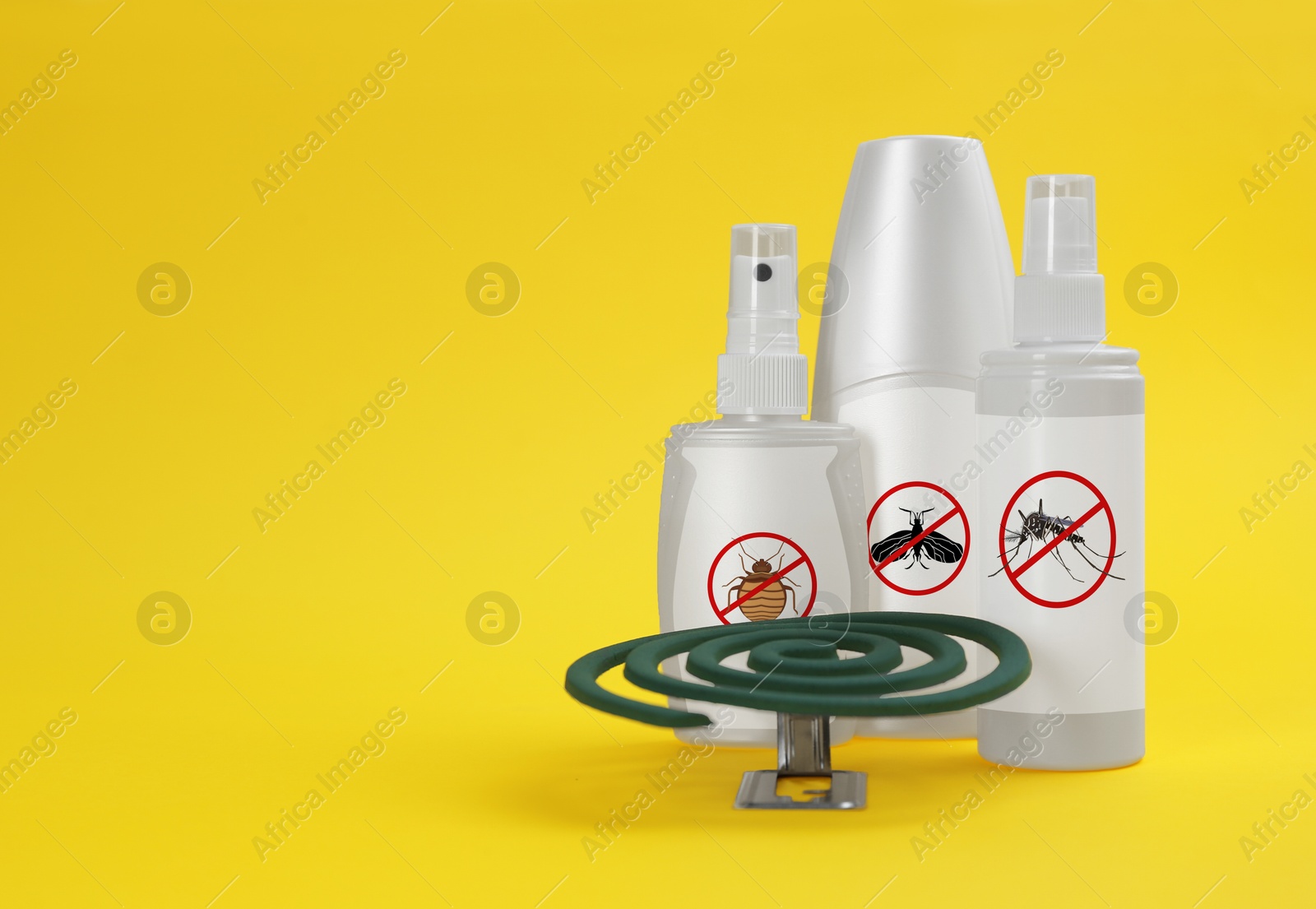 Image of Mosquito coil and other insect repellents on yellow background, space for text