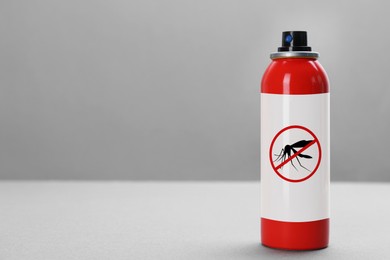 Mosquito spray on grey background, space for text. Insect repellent