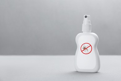 Mosquito spray on grey background, space for text. Insect repellent