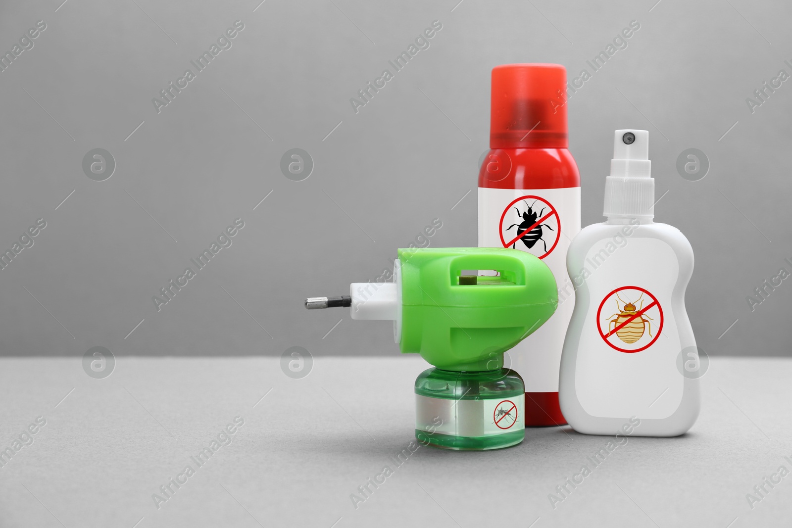 Image of Mosquito vaporizer and other insect repellents on grey background, space for text