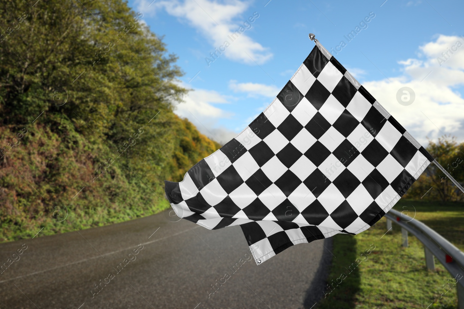 Image of Checkered finish flag and asphalt racing track outdoors