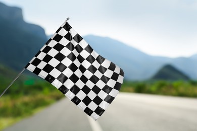 Checkered finish flag and asphalt racing track outdoors