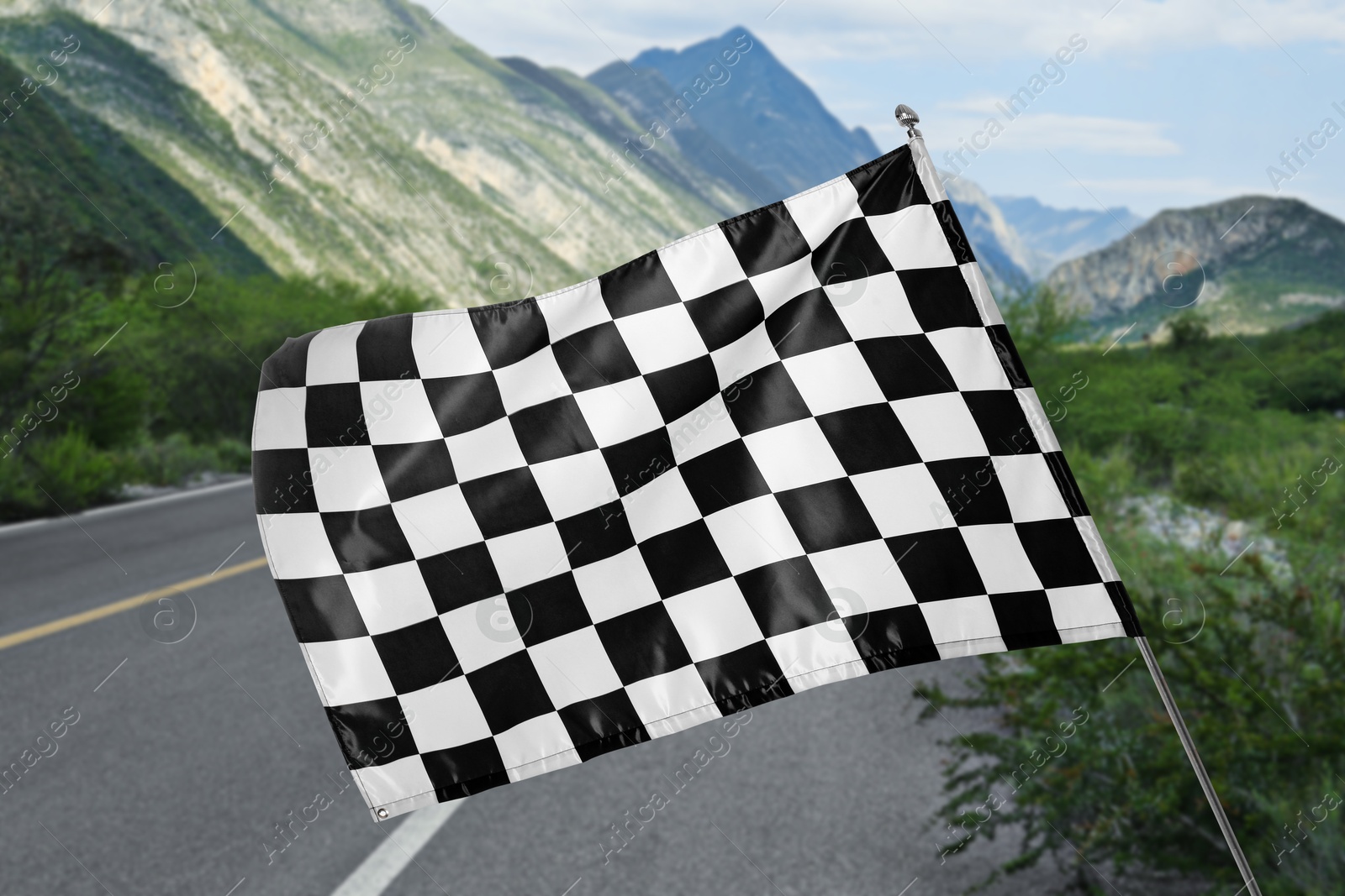 Image of Checkered finish flag and asphalt racing track outdoors