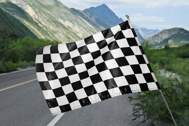 Image of Checkered finish flag and asphalt racing track outdoors