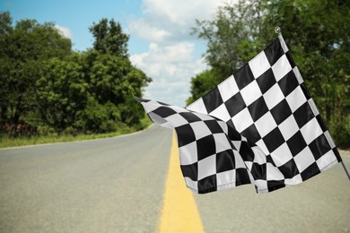 Checkered finish flag and asphalt racing track outdoors