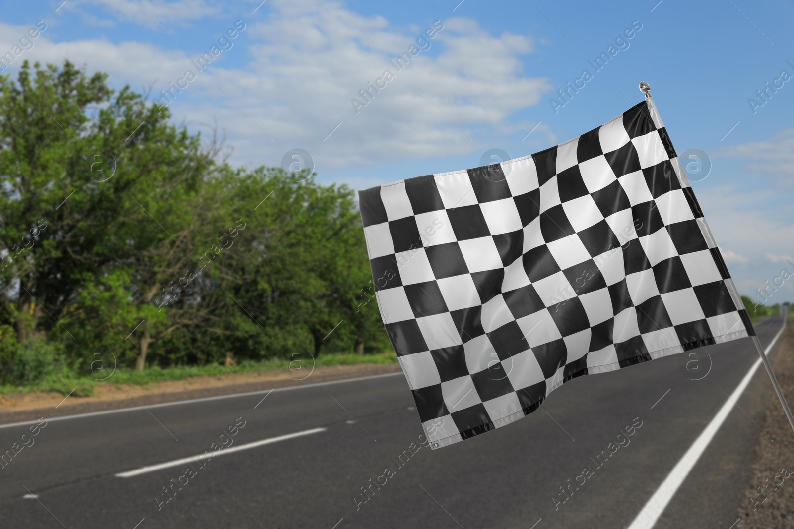 Image of Checkered finish flag and asphalt racing track outdoors