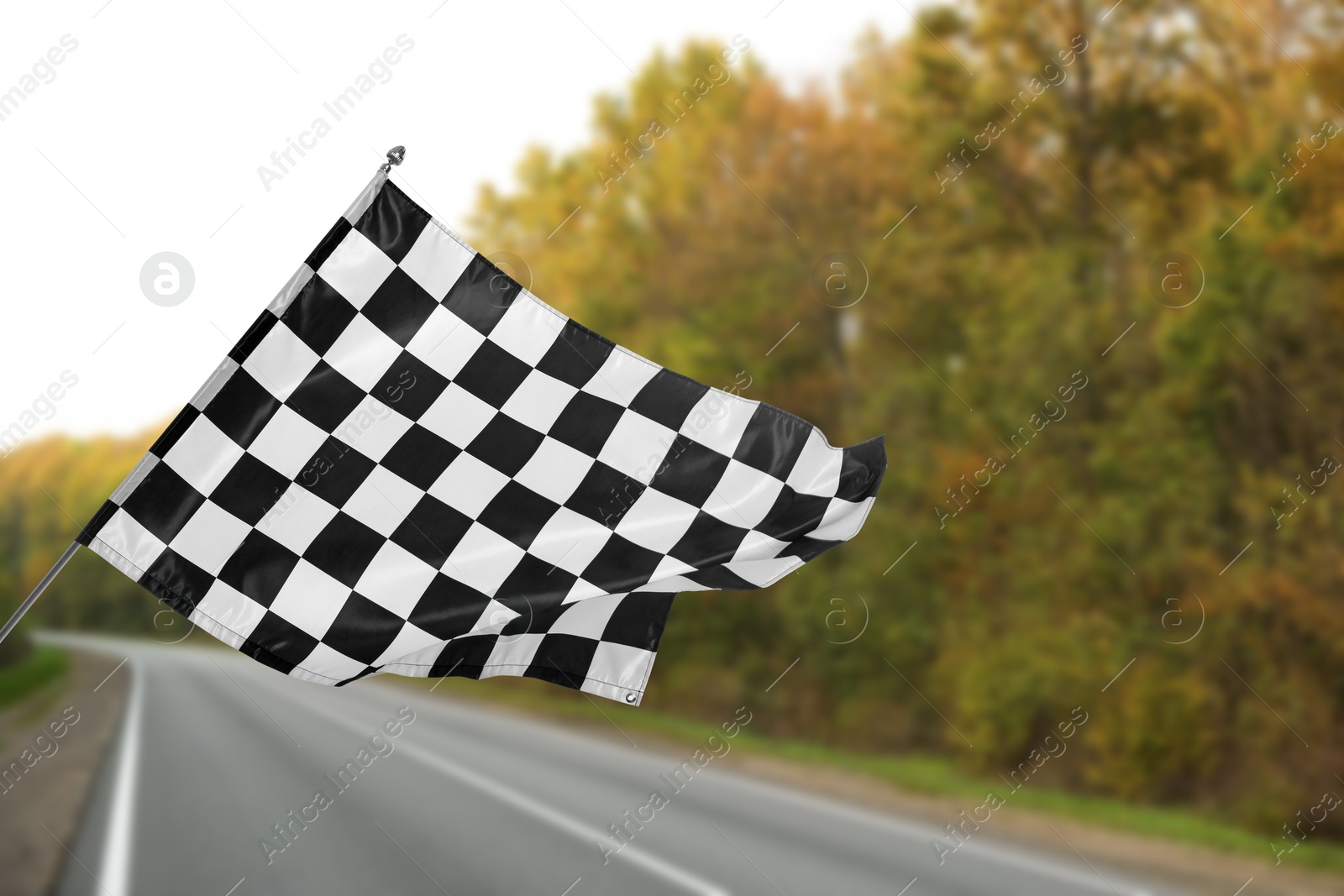 Image of Checkered finish flag and asphalt racing track outdoors