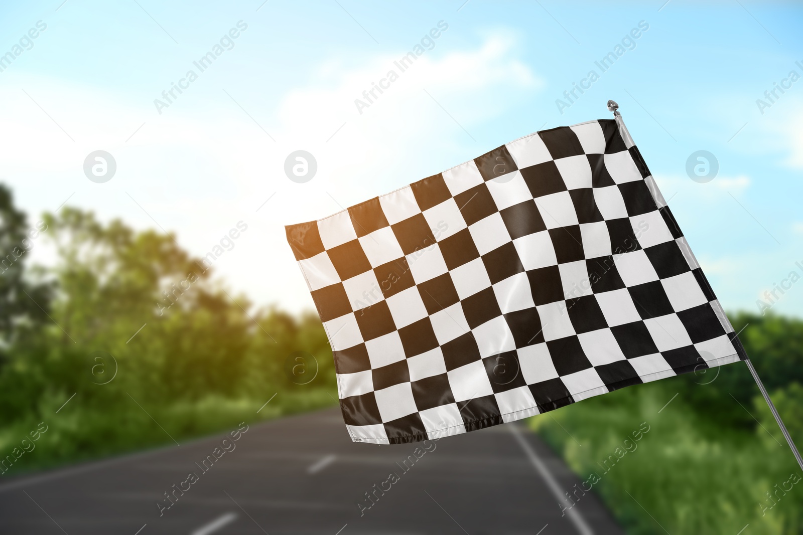 Image of Checkered finish flag and asphalt racing track outdoors