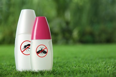 Mosquito sprays on green grass outdoors, space for text. Insect repellent