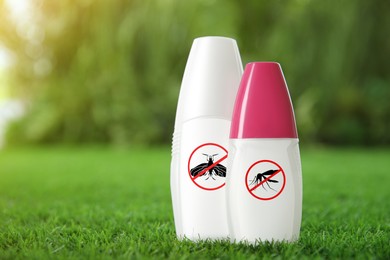 Mosquito sprays on green grass outdoors, space for text. Insect repellent