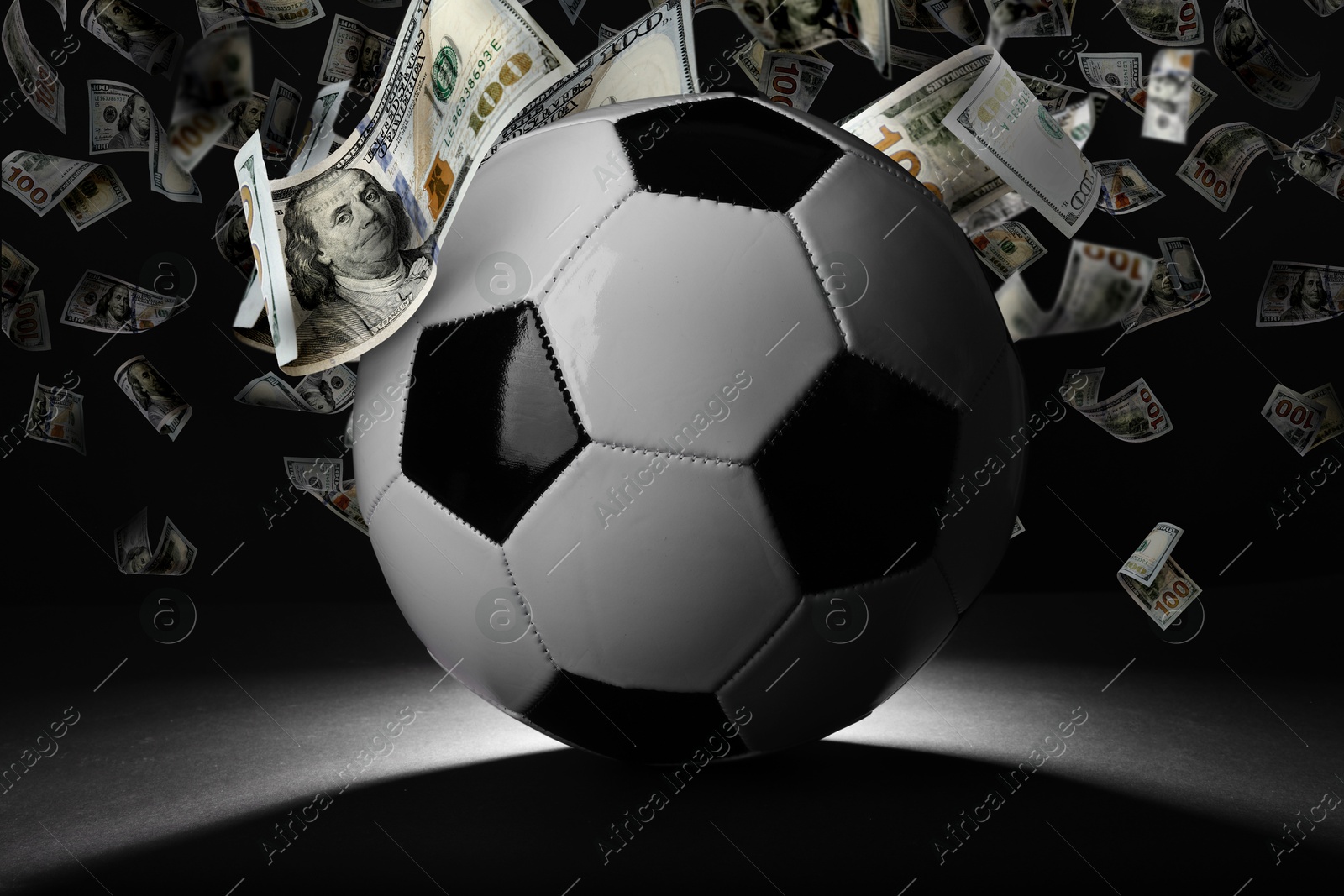 Image of Soccer ball under money rain on black background