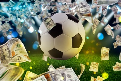 Image of Money and soccer ball in air at stadium