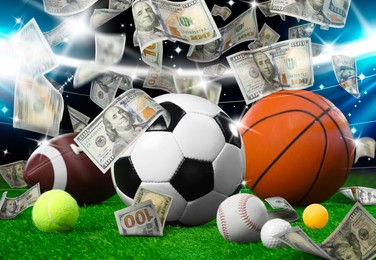 Image of Different sports balls under money rain on stadium