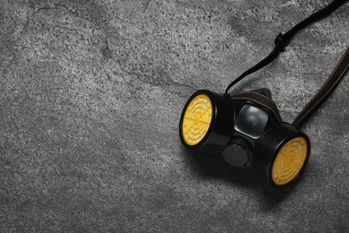 Photo of One respirator mask on grey table, top view. Space for text