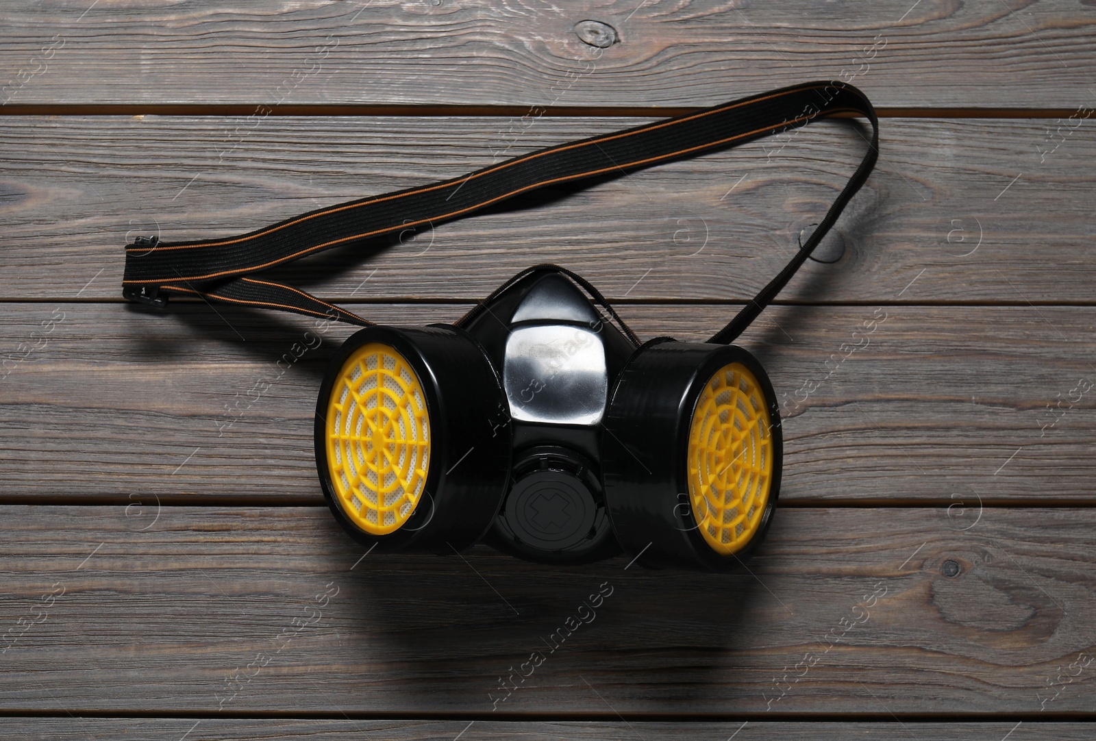 Photo of One respirator mask on wooden table, top view