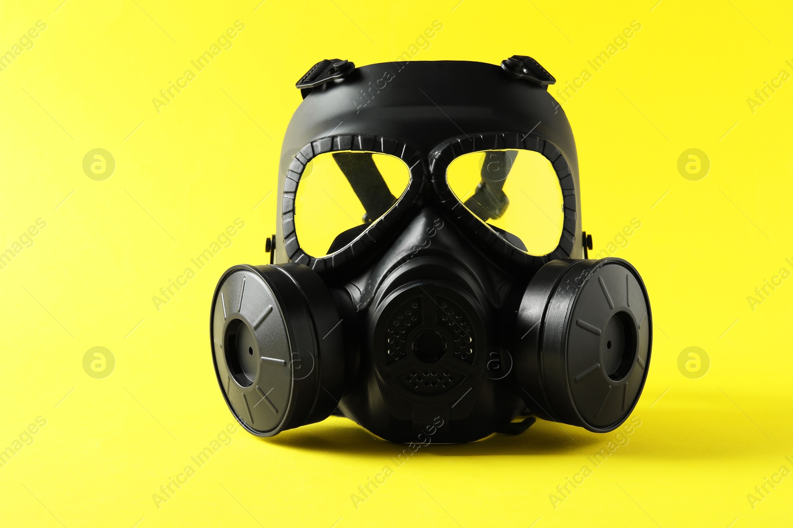 Photo of One gas mask on yellow background. Safety equipment