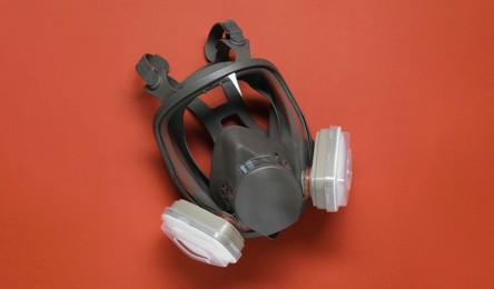 Photo of One full face respirator on red background, top view. Space for text