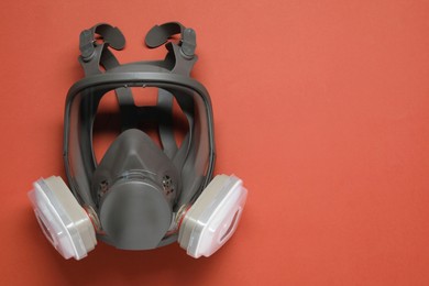 One full face respirator on red background, top view. Space for text