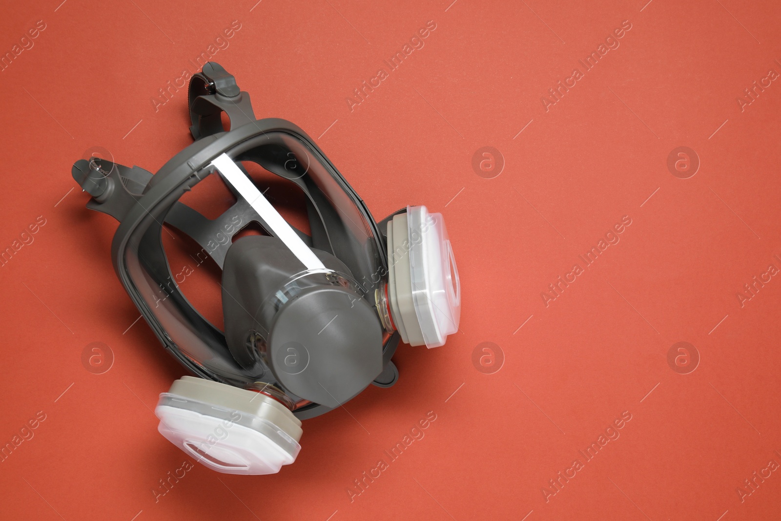 Photo of One full face respirator on red background, top view. Space for text