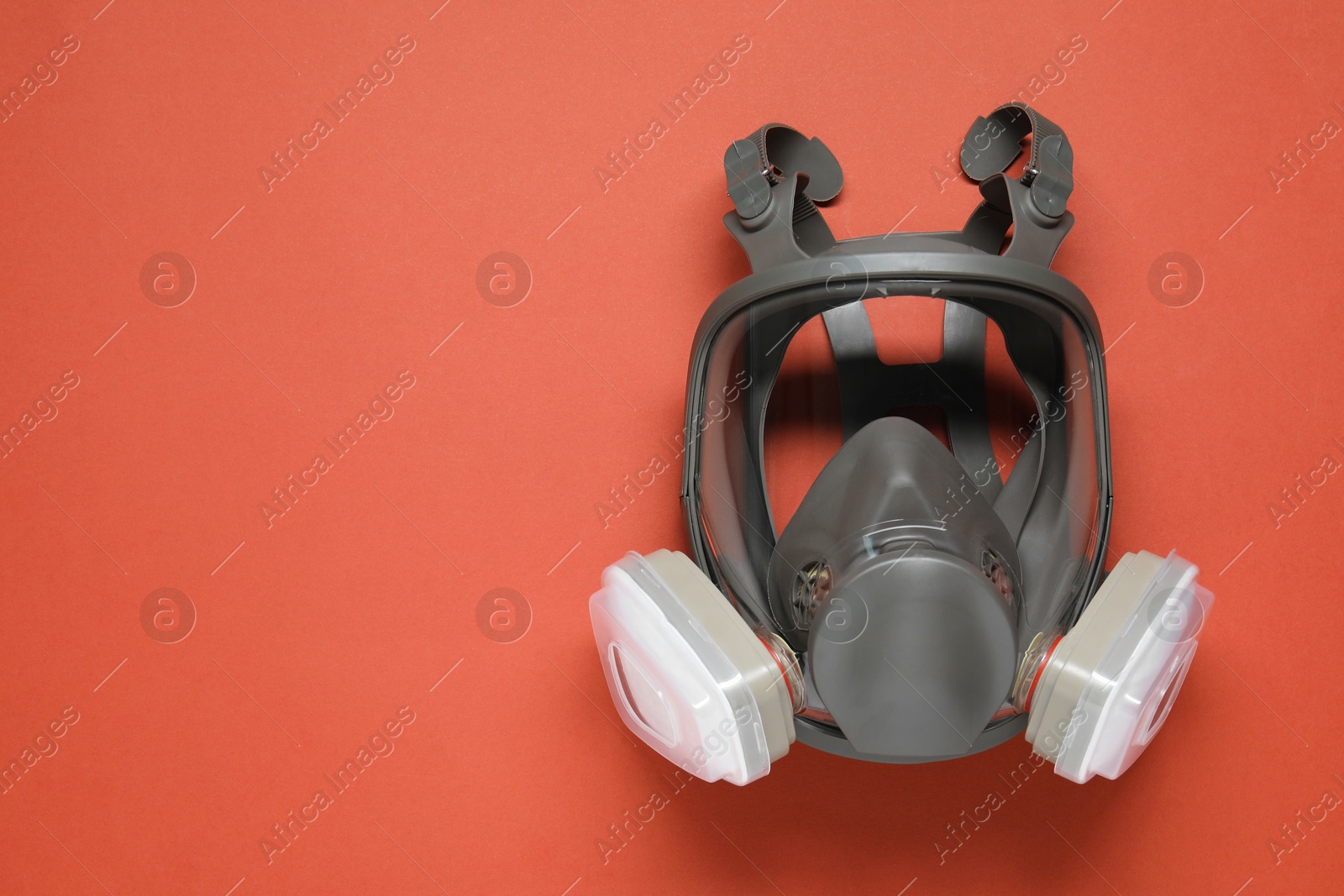 Photo of One full face respirator on red background, top view. Space for text