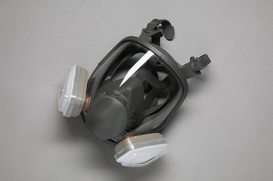 Photo of One full face respirator on grey background, top view