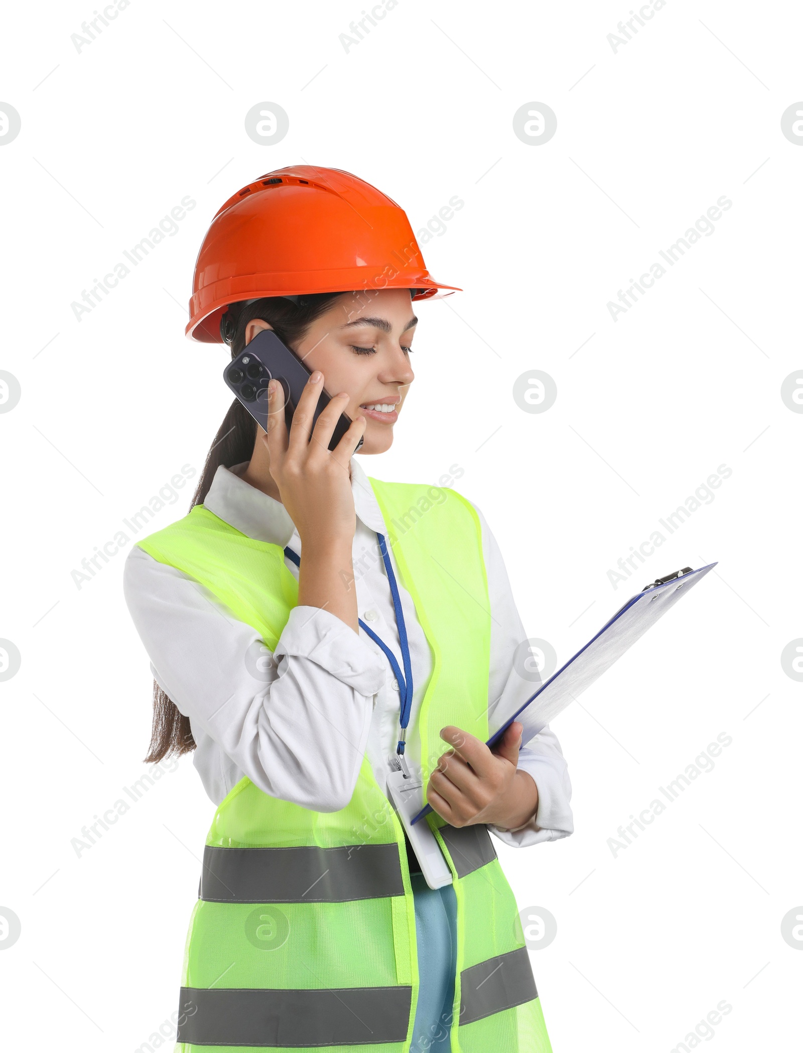 Photo of Engineer in hard hat with clipboard talking on smartphone against white background