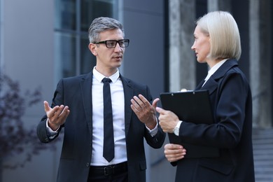 Photo of International relations. Diplomats talking during meeting outdoors