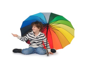 Photo of Little boy with rainbow umbrella on white background