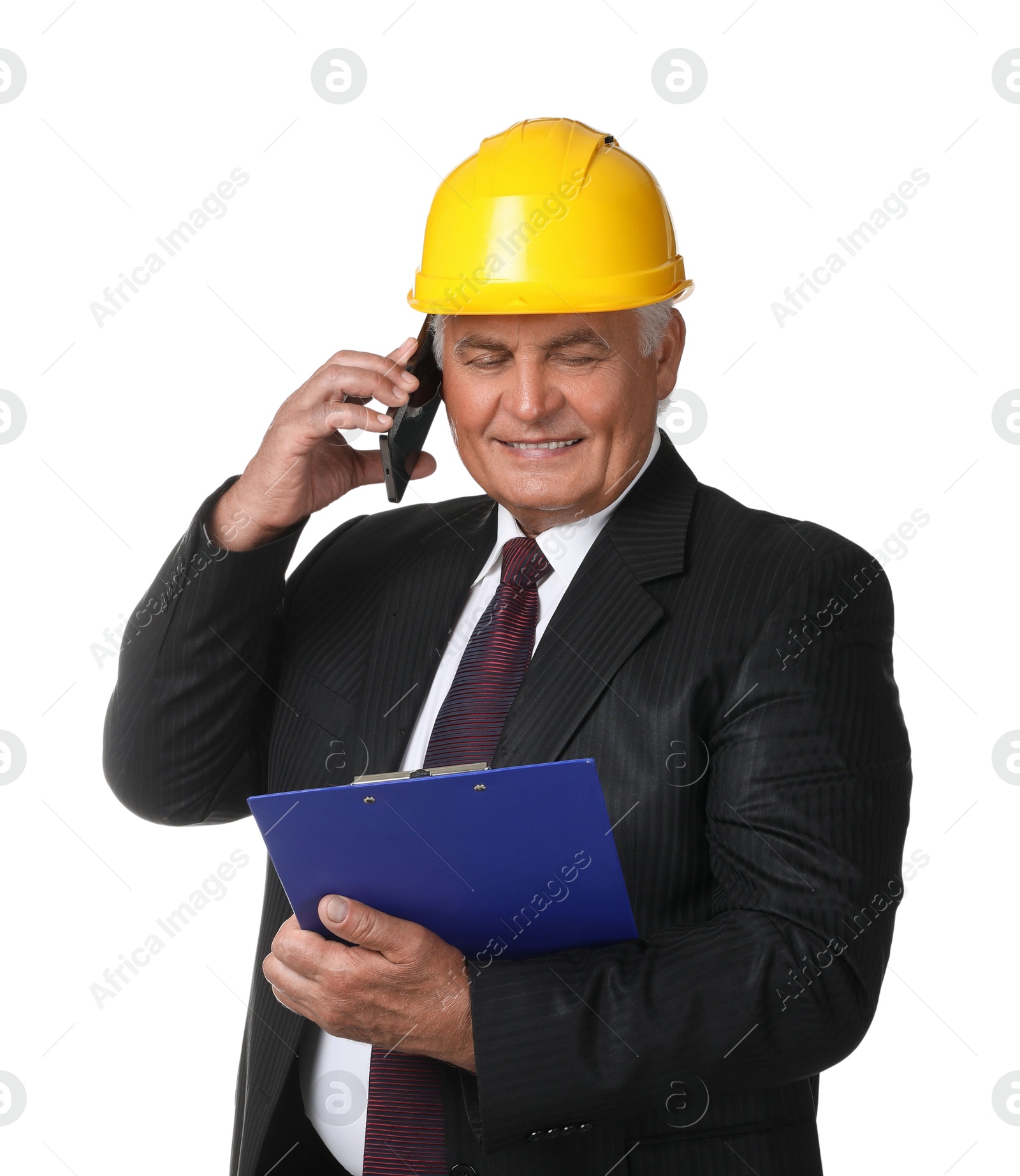 Photo of Engineer in hard hat with clipboard talking on smartphone against white background