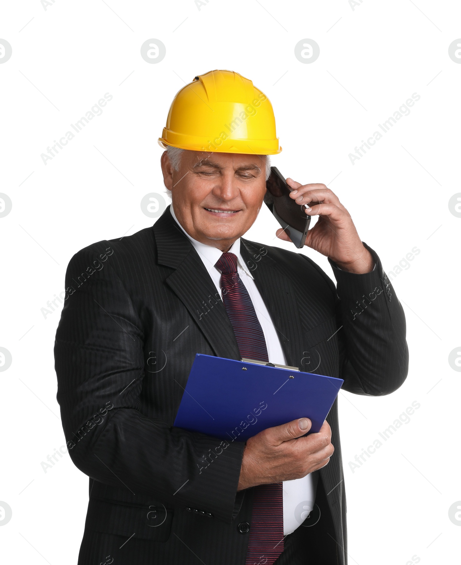 Photo of Engineer in hard hat with clipboard talking on smartphone against white background