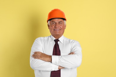 Engineer in hard hat on yellow background