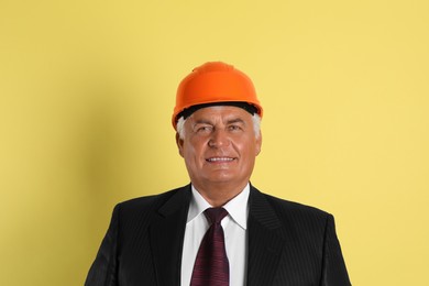 Engineer in hard hat on yellow background