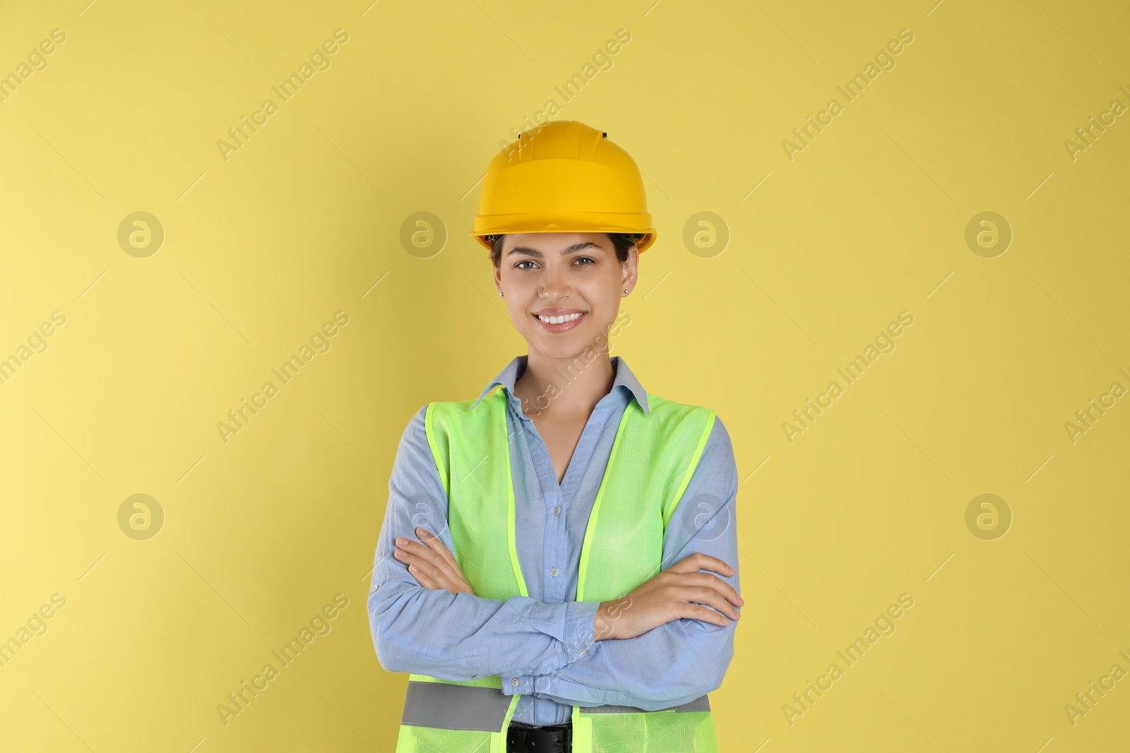 Photo of Engineer in hard hat on yellow background