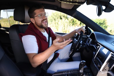 Man singing in car, view from inside