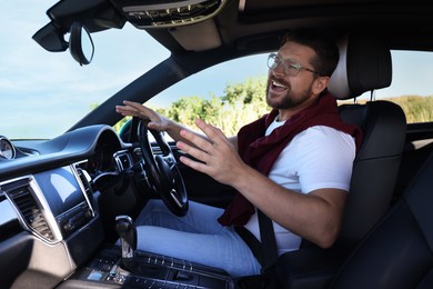 Photo of Man singing in car, view from inside