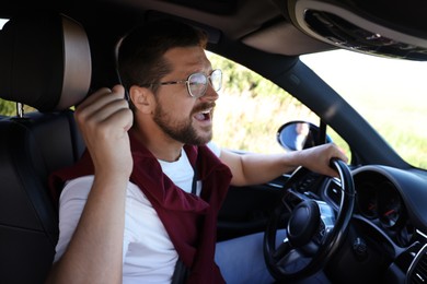 Man singing in car, view from inside