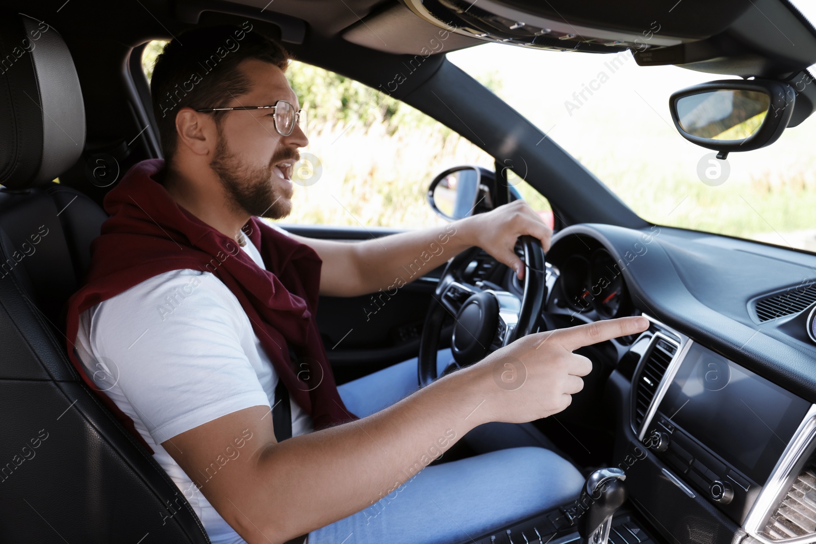 Photo of Man singing in car, view from inside