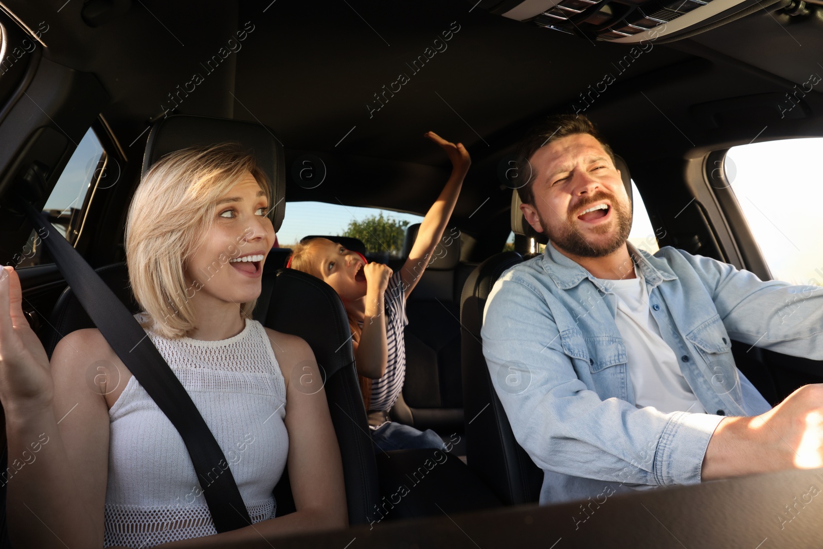 Photo of Happy family singing in car, view from inside