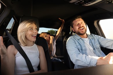 Photo of Happy family singing in car, view from inside