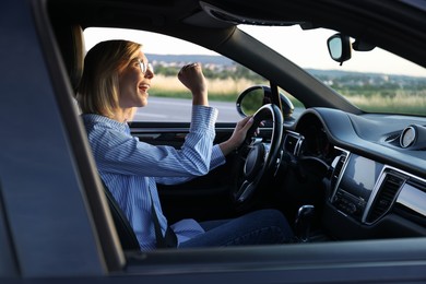 Photo of Woman singing in car, view from outside