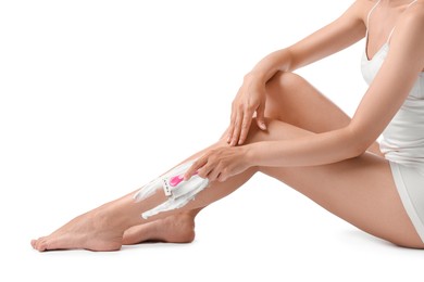 Woman shaving leg on white background, closeup