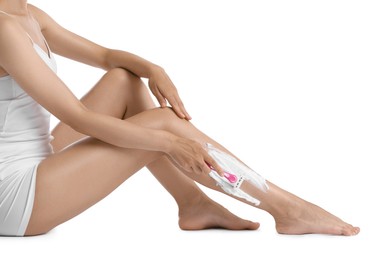 Photo of Woman shaving leg on white background, closeup