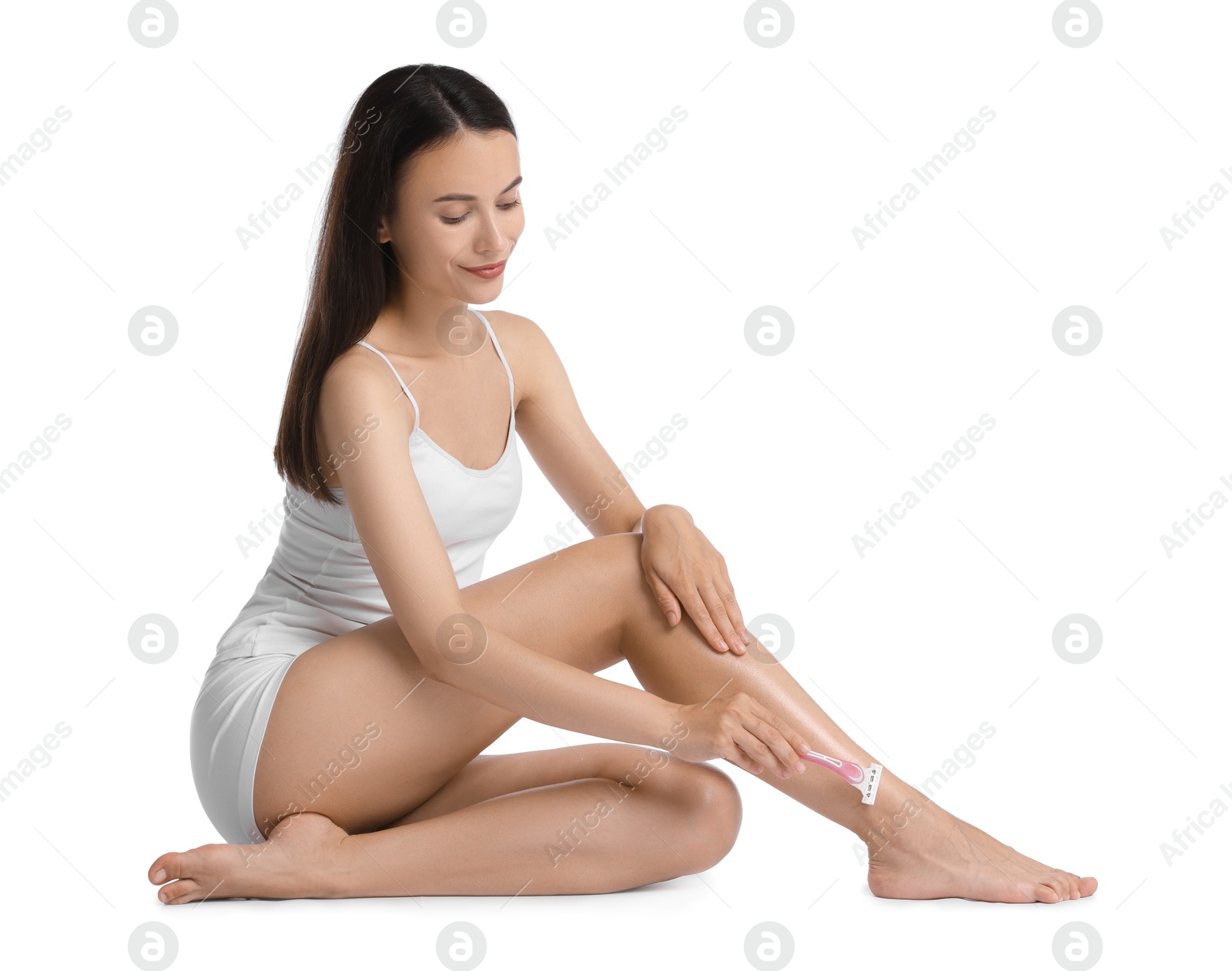 Photo of Beautiful woman shaving leg on white background