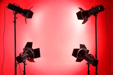 Red photo background and professional lighting equipment in studio